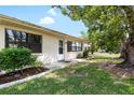 Home exterior showcasing lush landscaping, mature trees, and a well-maintained lawn in a serene, verdant setting at 1530 Ingram Dr # 1530, Sun City Center, FL 33573