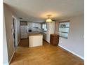 Well-lit kitchen featuring laminate wood floors and lots of cabinet storage space at 1542 Derrick St, Holiday, FL 34690