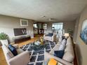 Spacious living room featuring stylish decor, hardwood floors, and plenty of natural light at 1542 Derrick St, Holiday, FL 34690
