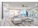 Inviting living room with a large sectional, chandelier, and views of the ocean at 1600 Gulf Blvd # 1112, Clearwater Beach, FL 33767