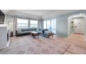 Bright living room featuring a fireplace, lots of windows, and modern decor at 2003 Cordova Grn, Seminole, FL 33777