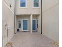 Between homes showcasing dual front doors, small garden, and paver flooring, providing an intimate entrance at 29901 Southwell Ln, Wesley Chapel, FL 33543