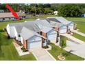 Aerial view of townhomes with gray roof and well maintained lawn at 3010 Beecher E Dr # A, Palm Harbor, FL 34683
