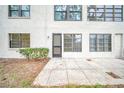 Outdoor patio with textured concrete and view of building facade, providing a relaxing outdoor space at 3038 Eastland Blvd # F102, Clearwater, FL 33761
