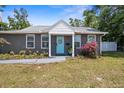 Charming single story home with a tidy landscaped yard and a decorative wreath on the front door on a sunny day at 3245 Freemont S Ter, St Petersburg, FL 33712