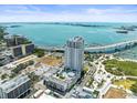 Sweeping aerial view featuring modern condo, waterfront access, and surrounding cityscape under a bright blue sky at 331 Cleveland St # 906, Clearwater, FL 33755
