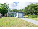 Beautiful single-story home with a well-maintained lawn, driveway, and colorful decorations at 351 Hancock St, Dunedin, FL 34698