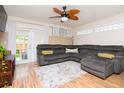 Cozy living room featuring hardwood floors, a ceiling fan, and comfortable gray sectional at 351 Hancock St, Dunedin, FL 34698