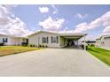 Charming single Gathering home with a spacious carport and well-maintained landscaping at 37642 Landis Ave, Zephyrhills, FL 33541