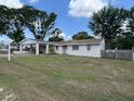 Cozy single-story home for sale with a large front yard, a carport, and a classic front door at 37913 Wicklow Ave, Zephyrhills, FL 33541