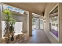 Inviting outdoor patio area with stone pavers, tropical plants, and an iron gate at 4694 Huron Rd, St Petersburg, FL 33708