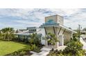 Exterior view of the Windwater Club clubhouse, featuring stone accents, modern architecture, and lush landscaping at 5012 124Th E Ave, Parrish, FL 34219