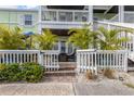 Charming exterior with a white picket fence, brick path, and lush tropical landscaping, perfect for coastal living at 5012 Starfish Se Dr # B, St Petersburg, FL 33705