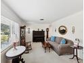 Spacious living room featuring a neutral color palette, large windows, and comfortable seating at 5812 52Nd N Ave, Kenneth City, FL 33709