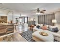 Open concept living and dining area featuring wood floors and a ceiling fan at 6409 N 23Rd St, Tampa, FL 33610