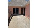 Exterior patio with stone pavers and a view of the sliding glass door and front door at 651 Boca Ciega Point S Blvd, St Petersburg, FL 33708