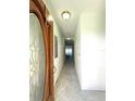 Foyer with decorative wood door and tile floors leading into the home at 651 Boca Ciega Point S Blvd, St Petersburg, FL 33708