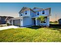 Inviting two-story home showcasing lush green grass, gray siding, and an attached two-car garage at 6807 162Nd Pl, Parrish, FL 34219