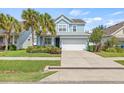 Charming two-story home with a well-manicured lawn and a two-car garage at 7710 S Desoto St, Tampa, FL 33616