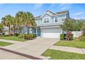 Charming two-story home with a well-manicured lawn and a two-car garage at 7710 S Desoto St, Tampa, FL 33616