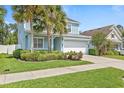 Charming two-story home with a well-manicured lawn and a two-car garage at 7710 S Desoto St, Tampa, FL 33616