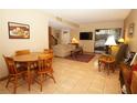 Inviting living room with tile flooring, neutral paint, comfortable seating and sliding glass doors to the outside at 8011 Peach Dr # 103, Tampa, FL 33637