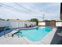 Sparkling pool surrounded by a patio, white fence and lounge chairs for relaxation and enjoyment at 8305 75Th Pl, Seminole, FL 33777