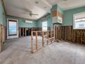 Open-concept living room showcasing exposed framing and vaulted ceilings presents an opportunity for customization at 13326 1St E St, Madeira Beach, FL 33708