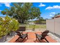 Relaxing patio featuring two chairs, red brick, and a beautiful view of the waterfront at 13751 Juniper Blossom Dr, Tampa, FL 33618