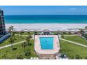 Relaxing pool area with tropical landscaping, lounge chairs, and beach views for leisure enjoyment at 1400 Gulf Blvd # 804, Clearwater Beach, FL 33767