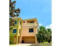 Stylish townhome with a private balcony, two-car garage, complemented by lush tropical landscaping at 1503 Citrine Trl, Tarpon Springs, FL 34689
