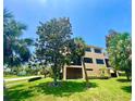 Spacious condo with large windows, screened in porch and lush greenery surrounding property at 1503 Citrine Trl, Tarpon Springs, FL 34689