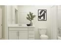 Bright bathroom featuring a vanity with modern fixtures and a framed mirror at 15091 Zircon Red Dr, Wimauma, FL 33598