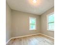 Bright bedroom featuring two windows and wood-look floors at 1536 S Martin Luther King Jr Ave, Clearwater, FL 33756