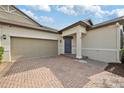 Attractive home featuring a two-car garage and a welcoming entryway at 16866 Balance Cv, Land O Lakes, FL 34638