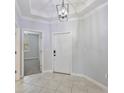 Bright entryway with tiled floors and a modern light fixture at 16866 Balance Cv, Land O Lakes, FL 34638