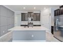 Modern kitchen with a large island and stainless steel appliances at 16866 Balance Cv, Land O Lakes, FL 34638