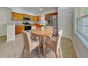 Bright kitchen featuring stainless steel appliances, light wood cabinetry, and an adjacent dining area with seating at 1850 Fuller Dr, Clearwater, FL 33755