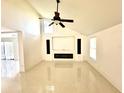 Spacious living room with high ceilings, tile flooring, and a modern fireplace at 2233 Springwood W Cir, Clearwater, FL 33763