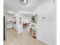 Bright hallway with neutral tile flooring leading to the kitchen and living areas at 2333 Feather Sound Dr # B309, Clearwater, FL 33762