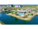 Aerial view of a community pool and clubhouse surrounded by lush landscaping at 2333 Feather Sound Dr # B309, Clearwater, FL 33762