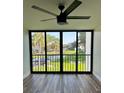 Balcony with ceiling fan, view of lake, green space, and trees at 2424 W Tampa Bay Blvd # 203, Tampa, FL 33607