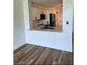 Modern white kitchen featuring countertops, a breakfast bar, updated appliances and wood-look flooring at 2424 W Tampa Bay Blvd # 203, Tampa, FL 33607