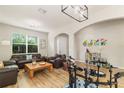 Bright living room with hardwood floors, a large window, modern lighting and neutral paint at 2903 Cypress Bowl Rd, Lutz, FL 33558