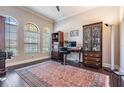 Bright office with natural light from large windows and a stylish rug at 32242 Summerglade Dr, Wesley Chapel, FL 33545