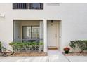 Charming condo entrance featuring a cozy screened patio and well-kept landscaping at 3366 Mermoor Dr # 1106, Palm Harbor, FL 34685
