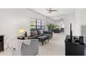 Bright living room with neutral tones, stylish furnishings, and a large mirror wall at 3366 Mermoor Dr # 1106, Palm Harbor, FL 34685