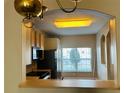 Open concept kitchen with modern appliances and light wood cabinetry at 3531 High Hampton Cir, Tampa, FL 33610