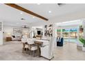Open-concept dining area leading to living room and poolside space with great natural light at 3912 Doral Dr, Tampa, FL 33634
