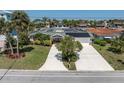 Single-story home featuring a lush yard, solar panels, and wide driveway at 4055 Floramar Ter, New Port Richey, FL 34652